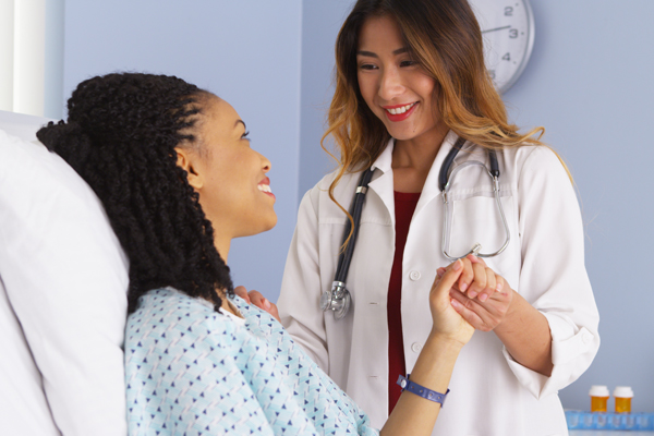 Doctor holding hand of patient