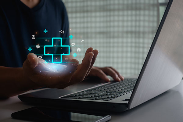 hospital symbol and person behind desk