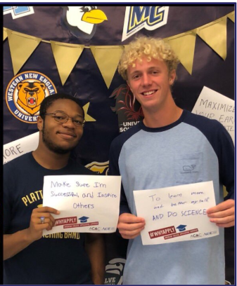 two students holding written goals