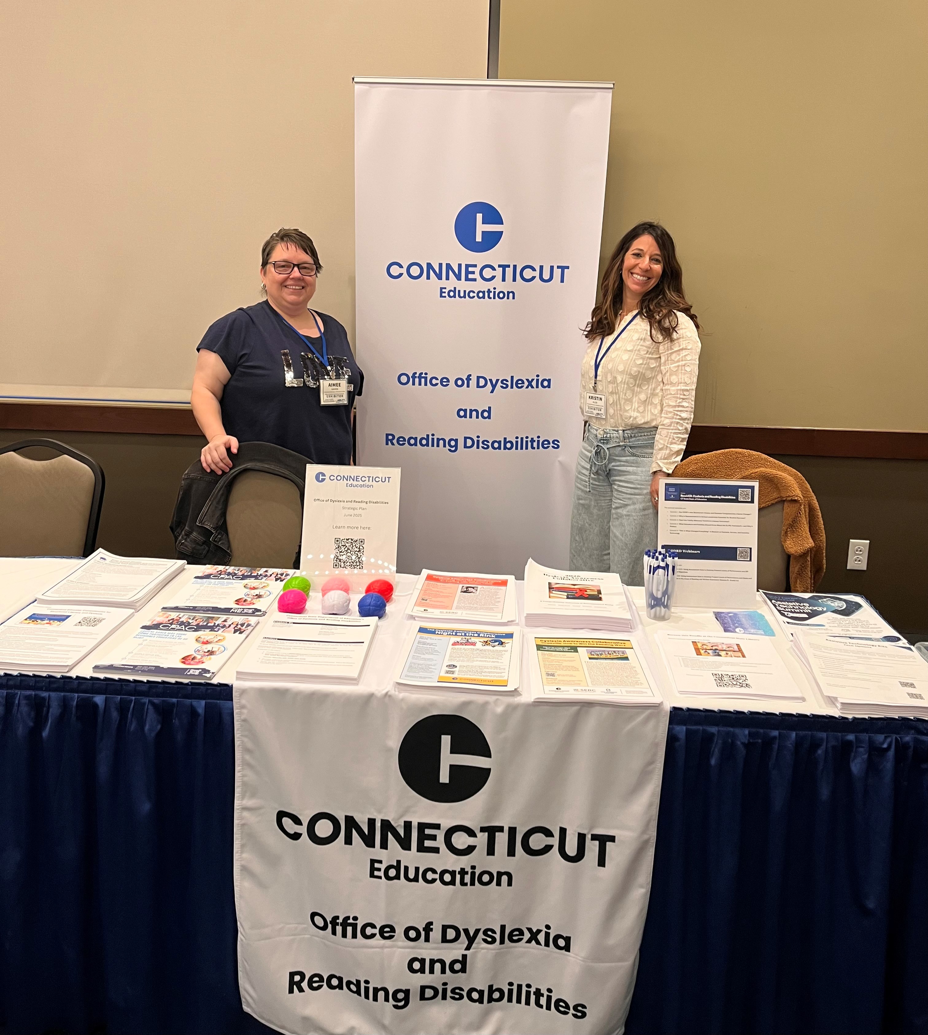 A photo of the ODRD display table with two people standing behind it.