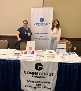 A photo of the ODRD display table with two people standing behind it.