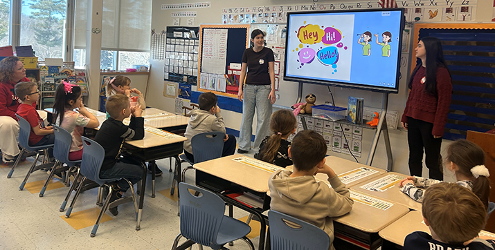 Student ambassadors presenting to a classroom of elementary students