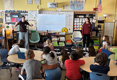 Student ambassadors presenting to a classroom of elementary students