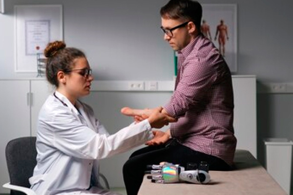 Doctor examines man’s arm