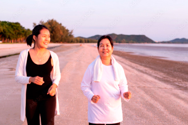 Women exercise on beach
