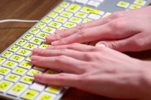 Person using Braille keyboard