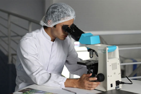 lab tech with microscope