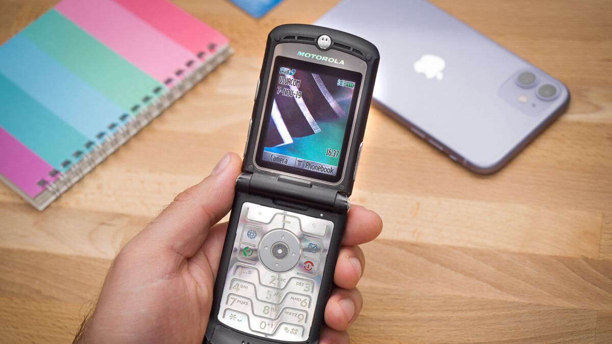 Photo of person holding a flip cell phone. Photo courtesy of Photoareana.com