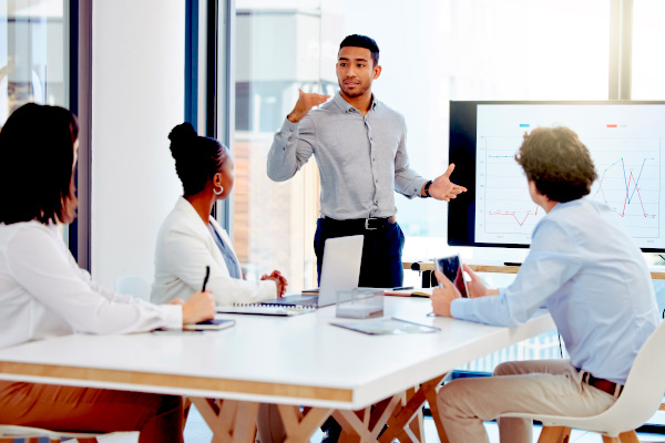 Businessman, meeting and coaching in presentation for data, graph or chart on team project at office.