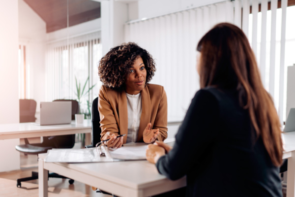 Two office workers talking.