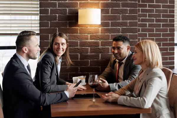 Two women and two men having a talk in a table