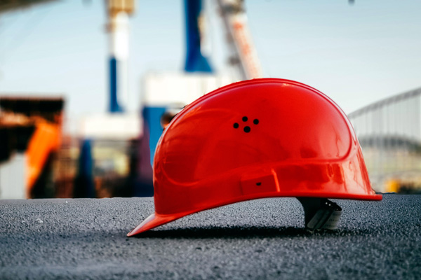 Hard hat on pavement.