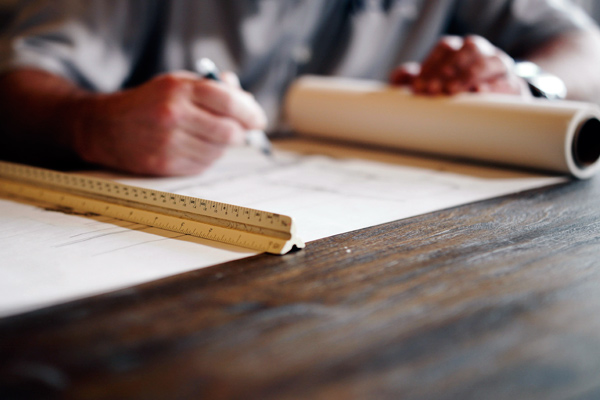 Man drawing blueprints.