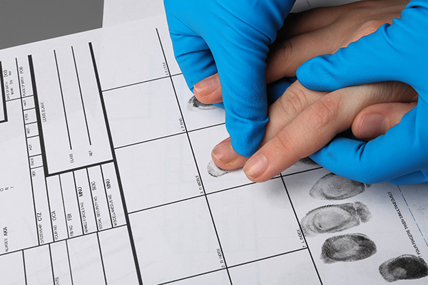 Person being fingerprinted.
