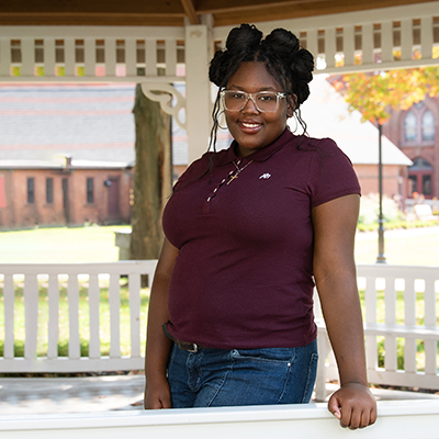 a teenage girl smiles in a gazebo