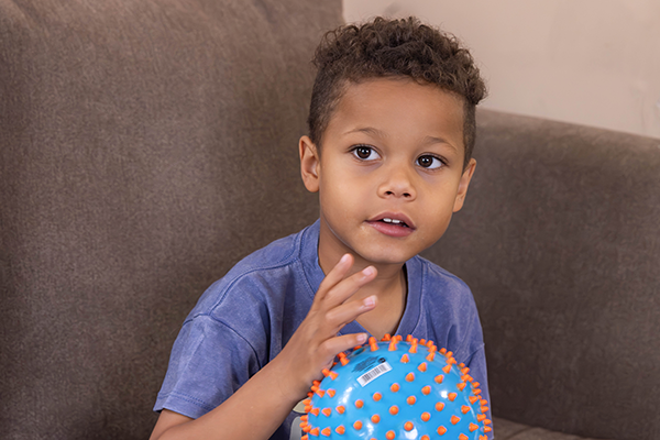 little boy holds a ball