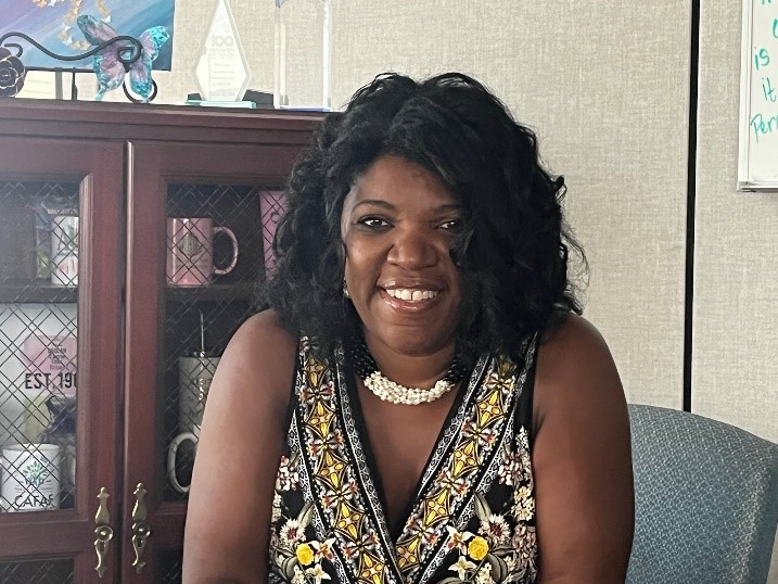 Photo of Commissioner Dorantes in a patterned black and yellow shirt with a pearl necklace.