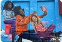 Photo of part of the mural on the Hartford Office. A Black father sits doing his daughter's hair while his other daughter does his hair. The family is happy and smiling.