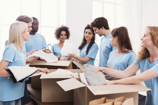 Group of individuals at a clothing drive. Decorative image for an informational page about charities.