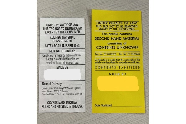 Image of white and yellow furniture tags with furniture item details. White means new furniture, yellow means used