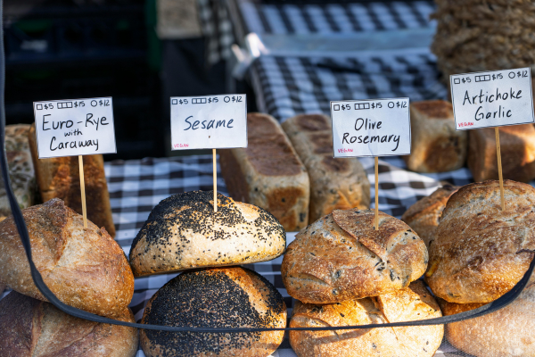 Four types of bread loaves on display at farmers market