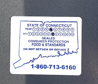 Blue and white stickers indicate the last time a gas pump was inspected by DCP. Station pumps are typically inspected every two years.