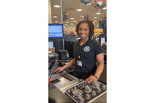 Image of Weights and Measures Inspector at grocery store to test scale at checkout counter