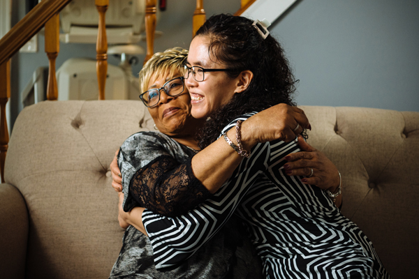 Two individuals hugging