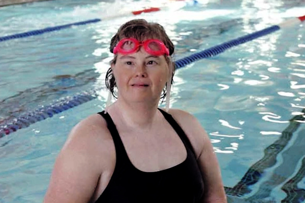 Pictured is Lisa Ellis, a lifeguard and swim instructor at the YMCA in Fairfield, CT, standing in a swimming pool,
