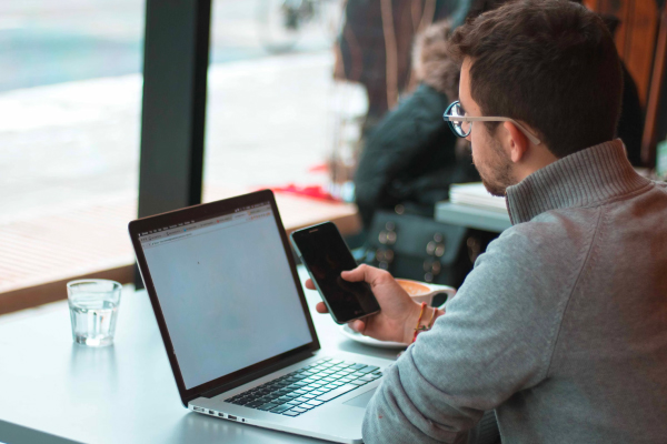A person reading newsletter on laptop