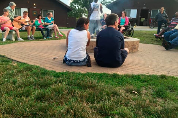 two people sitting in a group