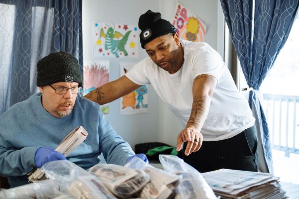 Direct service professional supporting an individual on newspaper delivery
