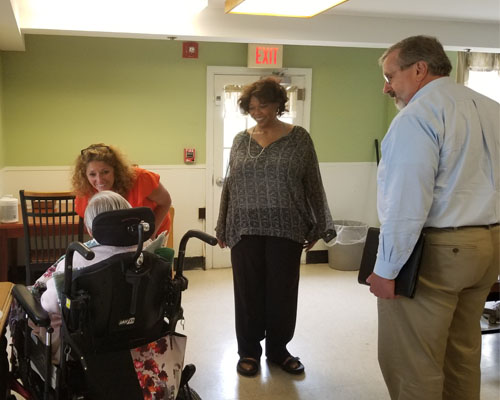 Representative Wilson Pheanious and DDS staff chat with an STS resident prior to snack time about their day