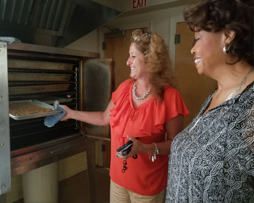Representative Wilson Pheanious and Day Program Supervisor, Donna Munson, discuss a dog biscuit program at STS