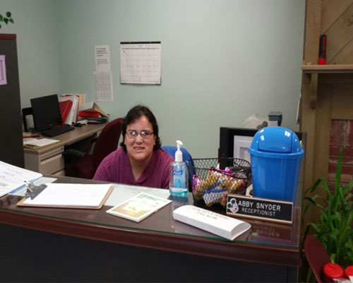 Abby Snyder sitting at a desk at work