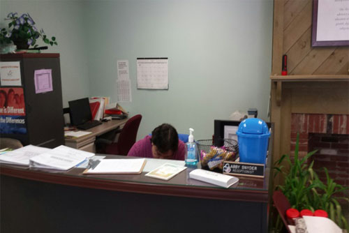 Abby Snyder sitting at a desk at work