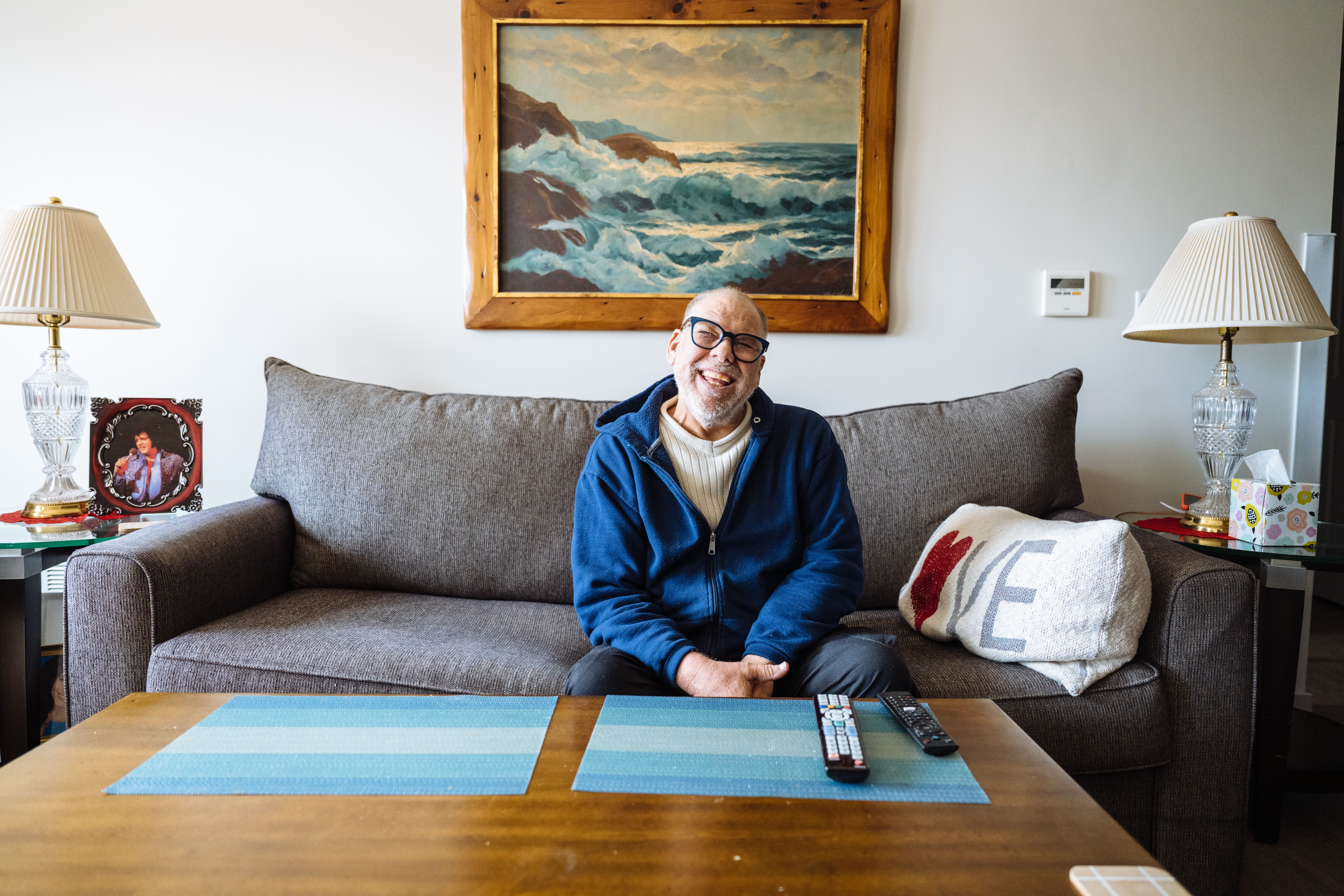 Supportive housing, Connecticut Developmental Services. Individual sitting on a couch in his home. 
