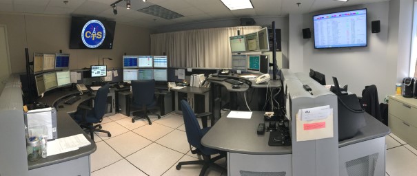 Network Control Center monitoring room with multiple operator workstations