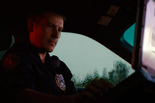 Officer on laptop in car