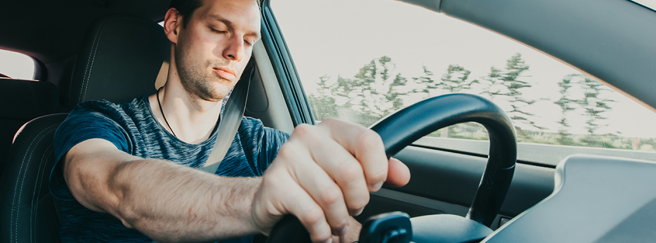 impaired driver driving a car with eyes closed