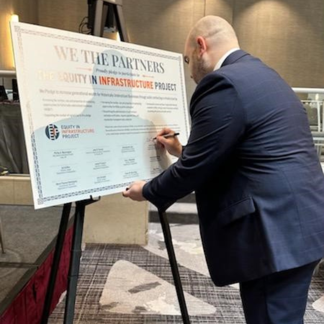 CTDOT Commissioner Garrett Eucalitto signing an Equity in Infrastructure Project Pledge