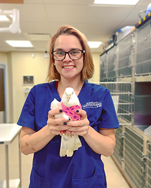 Vet Tech holding a bird.