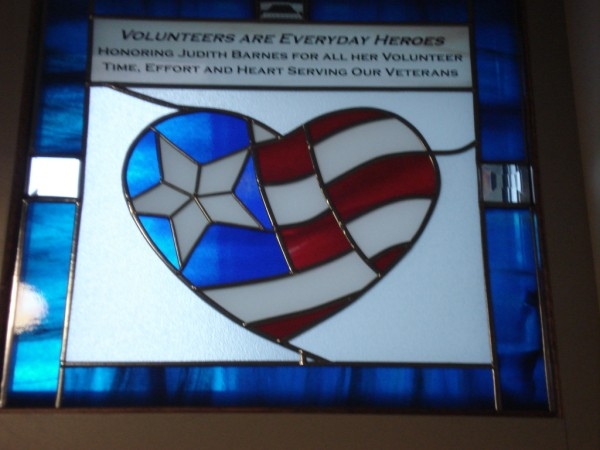 Stained glass window of the American Flag in the shape of a heart