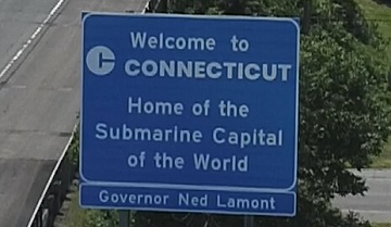 Interstate highway sign that says, "Welcome to Connecticut, Home of the Submarine Capital of the World."