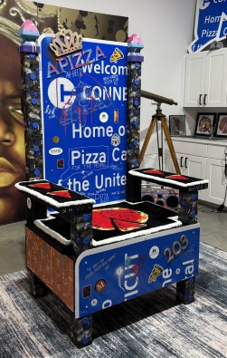 Custom-designed art installation of a pizza-themed throne using Connecticut highway signs
