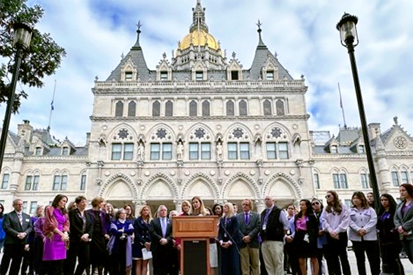 Front View of the State Capitol Building with the Lieutenant Governor giving a Press Conference.