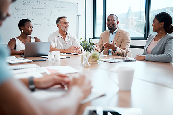 A group of people in an office having a meeting.