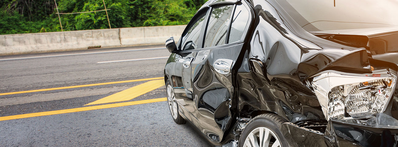 a black crashed car on highway - crash course