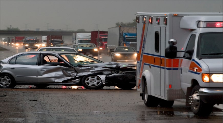 crashed silver car on highway behind an ambulance - crash course uconn data