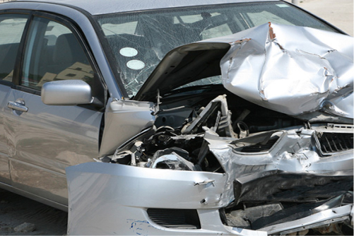 badly crashed silver car in front